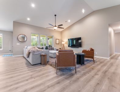 Spacious living room with vaulted ceilings and 85-inch TV at Bandon's Trail House