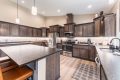 Spacious kitchen with dark wood cabinets and pendant lighting at Bandon's Trail House