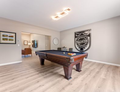 Custom pool table and Bandon Dunes golf art in the game room at Trail House