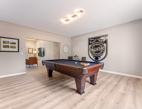 Custom pool table and Bandon Dunes golf art in the game room at Trail House