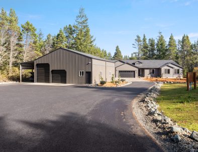 Bandon's Trail House full property view with shop building and circular driveway