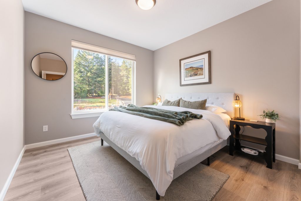 Serene king bedroom with large windows overlooking putting green at Bandon Dunes rental house