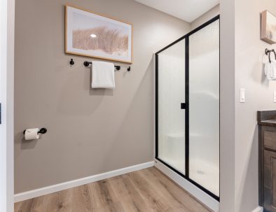 Guest bathroom with walk-in shower, coastal artwork, and modern fixtures at Bandon Dunes vacation rental