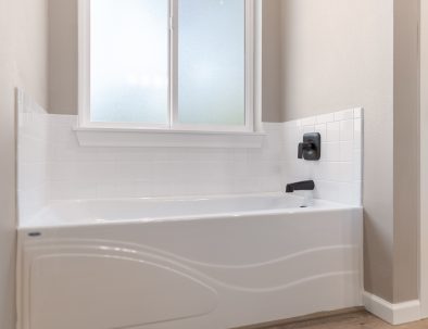 Bathroom with soaking tub, white subway tile, and window at Bandon Dunes rental house