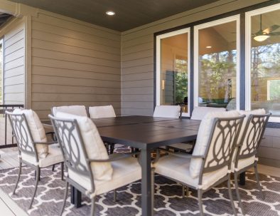 Outdoor dining area on covered patio with table and chairs at Bandon's Trail House