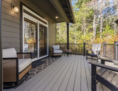 Spacious deck with lounge seating and forest views at Bandon Dunes vacation rental