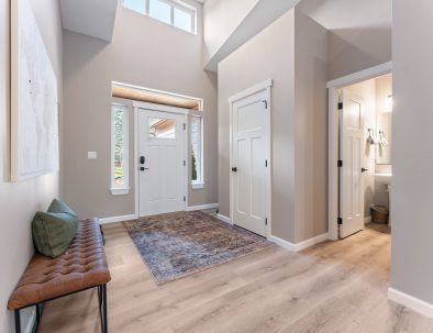 Vaulted entryway with leather bench and half bath at Bandon Dunes rental house